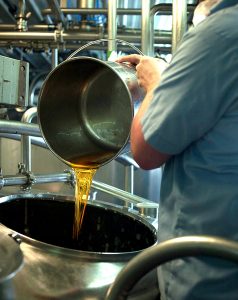 FINISHING TOUCH Just the right amount of local honey is added before bottling.